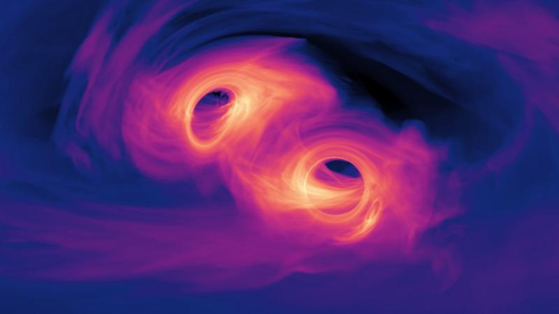 Visualization of a computer simulation showing two super massive black holes orbiting one another closely.